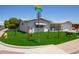 Well-maintained home featuring a brick-paved driveway and lush landscaping, offering great curb appeal at 5122 E Emerald Cir, Mesa, AZ 85206