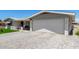 Single Gathering home featuring a two car garage, front patio and low maintenance landscaping at 5122 E Emerald Cir, Mesa, AZ 85206