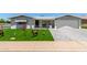 Charming home featuring an immaculate lawn, manicured landscaping, and brick-paved driveway at 5122 E Emerald Cir, Mesa, AZ 85206