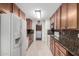 Efficient kitchen design with full appliance set, granite counters and tiled floors at 5122 E Emerald Cir, Mesa, AZ 85206