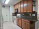 Traditional kitchen featuring wooden cabinets, mosaic backsplash, and granite countertops at 5122 E Emerald Cir, Mesa, AZ 85206