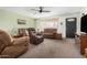 Cozy living room featuring comfortable seating, a ceiling fan, and a view of the entryway at 5122 E Emerald Cir, Mesa, AZ 85206