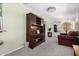 Spacious living room featuring a decorative hutch and neutral carpeting throughout at 5122 E Emerald Cir, Mesa, AZ 85206