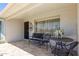 Inviting covered patio with neutral tile, seating area, and charming decor, perfect for relaxing outdoors at 5122 E Emerald Cir, Mesa, AZ 85206