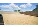 Vast backyard with dirt landscaping and block fencing, under a blue sky at 5956 N 188Th Ln, Litchfield Park, AZ 85340