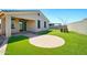 Backyard view featuring artificial turf, paver patio and extended covered patio at 5956 N 188Th Ln, Litchfield Park, AZ 85340