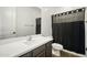 This bathroom features a single vanity and tiled shower with curtain at 5956 N 188Th Ln, Litchfield Park, AZ 85340
