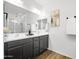 Modern bathroom features a double vanity, large mirror, and tiled shower at 5956 N 188Th Ln, Litchfield Park, AZ 85340
