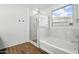 Bathroom featuring a glass shower and separate soaking tub beneath a window at 5956 N 188Th Ln, Litchfield Park, AZ 85340