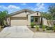 Charming single-story home with a two-car garage, desert landscaping and a light stucco finish at 5956 N 188Th Ln, Litchfield Park, AZ 85340