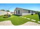 Backyard exterior of the home with small patches of artificial grass and pavers at 5956 N 188Th Ln, Litchfield Park, AZ 85340