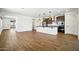 Modern kitchen with stainless steel appliances, a large island and wood-look flooring at 5956 N 188Th Ln, Litchfield Park, AZ 85340