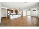 Spacious kitchen with stainless steel appliances, pendant lighting, and wood-look flooring at 5956 N 188Th Ln, Litchfield Park, AZ 85340