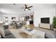 Open concept living room featuring a kitchen, a marble table and a comfortable seating area at 5956 N 188Th Ln, Litchfield Park, AZ 85340
