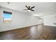 Bright and airy living room with tile floors, large windows, and a ceiling fan at 5956 N 188Th Ln, Litchfield Park, AZ 85340