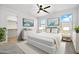 Stylishly furnished main bedroom with a ceiling fan, white furniture and carpeted flooring at 5956 N 188Th Ln, Litchfield Park, AZ 85340