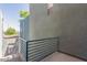 View from a balcony showing the building's exterior with blue railings and stucco walls at 615 E Portland St # 261, Phoenix, AZ 85004