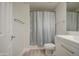 Updated bathroom with a shower featuring a light blue curtain, a white toilet, and a white vanity at 615 E Portland St # 261, Phoenix, AZ 85004