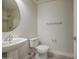 A bright bathroom features a pedestal sink and neutral colors at 615 E Portland St # 261, Phoenix, AZ 85004