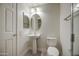 A bright bathroom features a pedestal sink and neutral colors at 615 E Portland St # 261, Phoenix, AZ 85004
