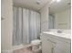 Updated bathroom with a shower featuring a light blue curtain, a white toilet, and a white vanity at 615 E Portland St # 261, Phoenix, AZ 85004