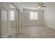 Bright bedroom featuring a ceiling fan, wood-look flooring, and window with white blinds at 615 E Portland St # 261, Phoenix, AZ 85004