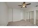 Bright bedroom featuring a ceiling fan, wood-look flooring, and a door to the rest of the house at 615 E Portland St # 261, Phoenix, AZ 85004