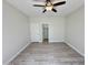 Bright bedroom features modern ceiling fan, closet, light-colored walls and hardwood floors at 615 E Portland St # 261, Phoenix, AZ 85004