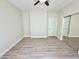 Light, bright bedroom with hardwood floors, neutral colored walls and mirrored closet at 615 E Portland St # 261, Phoenix, AZ 85004