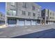 Exterior view of the condominium featuring garages, apartments, and a blue sky at 615 E Portland St # 261, Phoenix, AZ 85004