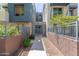 Inviting walkway leading to a gated front entrance surrounded by green landscaping and modern architecture at 615 E Portland St # 261, Phoenix, AZ 85004