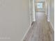 Bright hallway with wood-look floors leads to a sunlit room with a window at 615 E Portland St # 261, Phoenix, AZ 85004