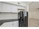 An eat-in kitchen features black appliances, light floors, and white cabinets at 615 E Portland St # 261, Phoenix, AZ 85004