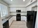 Updated kitchen boasts modern appliances, including a black range and refrigerator at 615 E Portland St # 261, Phoenix, AZ 85004