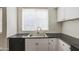 A stainless steel kitchen sink features a modern faucet and granite countertops at 615 E Portland St # 261, Phoenix, AZ 85004