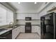 Bright kitchen features white cabinets, black appliances, and modern finishes at 615 E Portland St # 261, Phoenix, AZ 85004
