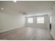 A bright open-plan living room with sleek wood floors and contemporary ceiling fan at 615 E Portland St # 261, Phoenix, AZ 85004