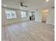 Spacious, bright living room with wood-look floors and a ceiling fan at 615 E Portland St # 261, Phoenix, AZ 85004
