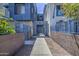 A beautifully landscaped walkway entrance into a modern apartment complex featuring secure gated access at 615 E Portland St # 261, Phoenix, AZ 85004