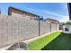 Backyard with a well-maintained block wall and artificial turf at 6328 W Fawn Dr, Laveen, AZ 85339