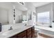 Bathroom featuring double sinks, bathtub and glass block window at 6328 W Fawn Dr, Laveen, AZ 85339