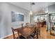 Stylish dining area with a wood table, six chairs, and views into the kitchen at 6328 W Fawn Dr, Laveen, AZ 85339