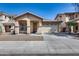 Charming single-story home with a well-maintained front yard, arched entryway, and a two-car garage at 6328 W Fawn Dr, Laveen, AZ 85339
