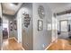 Hallway with wood flooring, decorative wall art, and doors leading to other rooms at 6328 W Fawn Dr, Laveen, AZ 85339