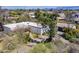 Aerial view showcasing a house with a red tile roof and mature trees on a large lot at 6418 E Sunnyside Dr, Scottsdale, AZ 85254
