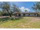 Spacious backyard with a mix of green and sandy areas, complemented by mature trees at 6418 E Sunnyside Dr, Scottsdale, AZ 85254