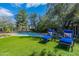 Backyard view with inviting pool, lush artificial turf, and comfortable chaise lounges for relaxing poolside at 6418 E Sunnyside Dr, Scottsdale, AZ 85254