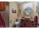 Bathroom with a vanity with oak cabinets, vessel sink, framed mirror, and walk-in shower at 6418 E Sunnyside Dr, Scottsdale, AZ 85254