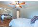 Bedroom featuring hardwood floors, a ceiling fan, and mirrored closet doors at 6418 E Sunnyside Dr, Scottsdale, AZ 85254