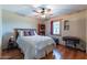 Bedroom with hardwood floors, ceiling fan, built-in bookcase, and a window with curtains at 6418 E Sunnyside Dr, Scottsdale, AZ 85254